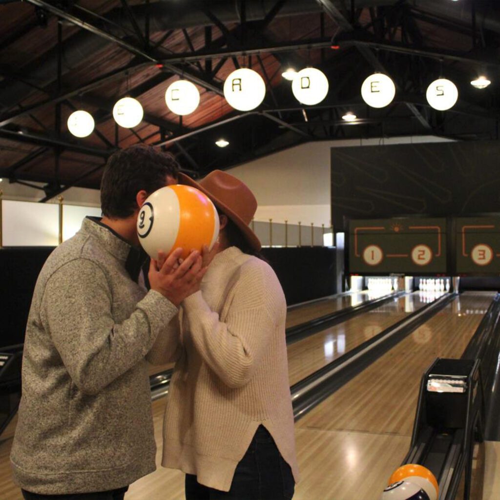 Couple Kissing behind bowling ball at Decades in Lancaster, PA