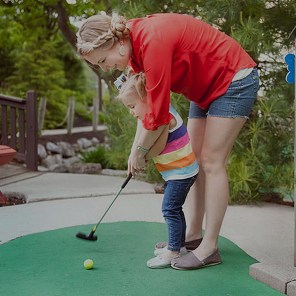 A mother and daughter playing mini golf at Water's Edge Golf on Ronks Road in Bird-in-Hand, PA.